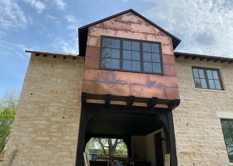 Copper metal panel facade on a stone building for Skylight Installation in Carolina Beach