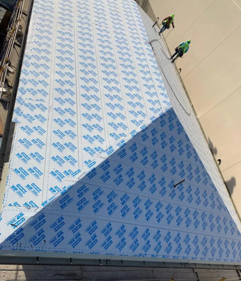 Professional roofers installing underlayment on a metal roof in Carolina Beach